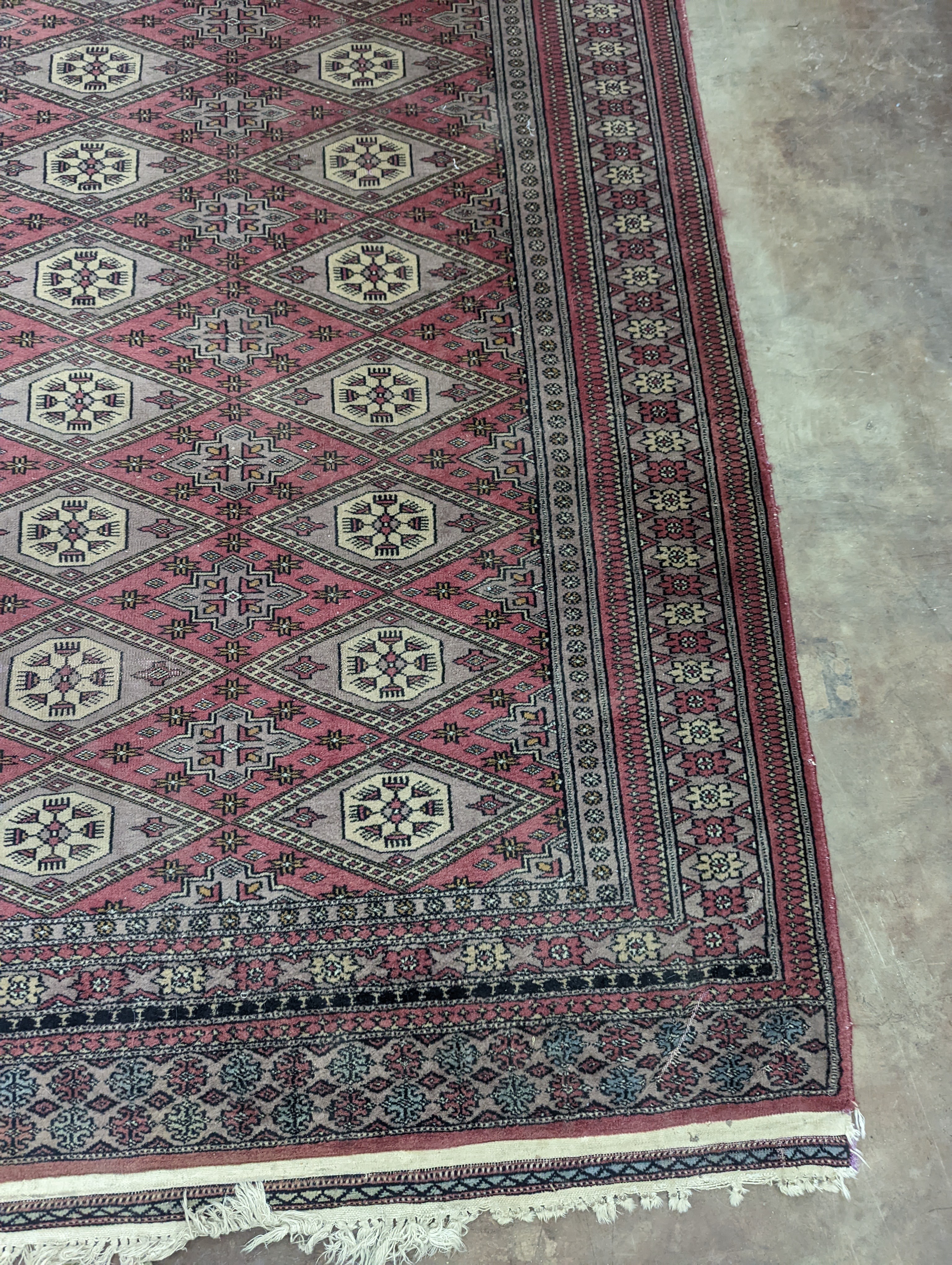 A Tekke Bokhara red ground rug, woven with rows of elephant feet, 180 x 126cm